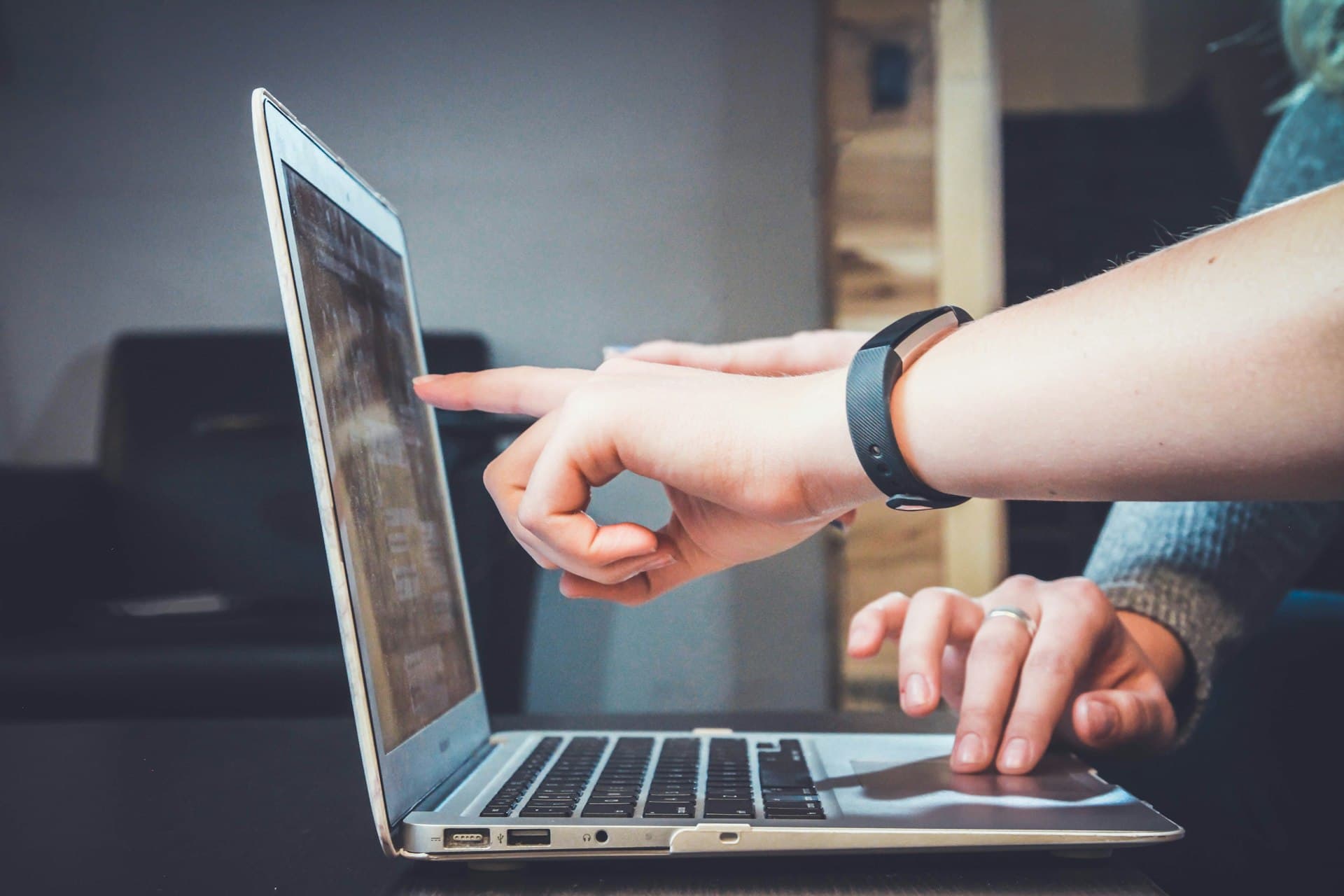 People collaborating around a laptop