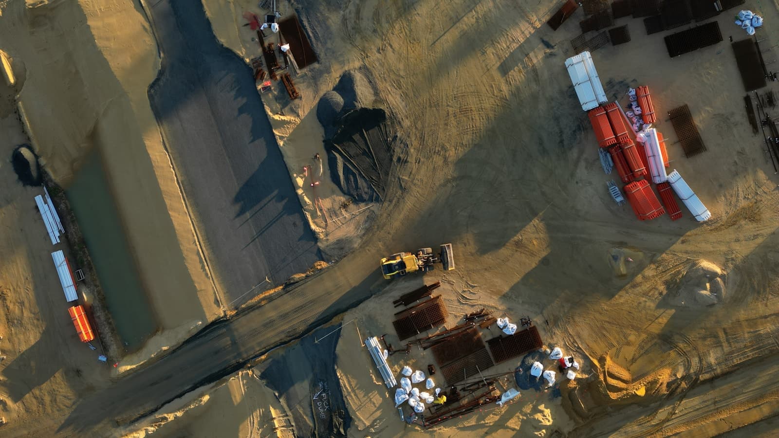 Aerial view of earthmoving equipment and materials at a construction site